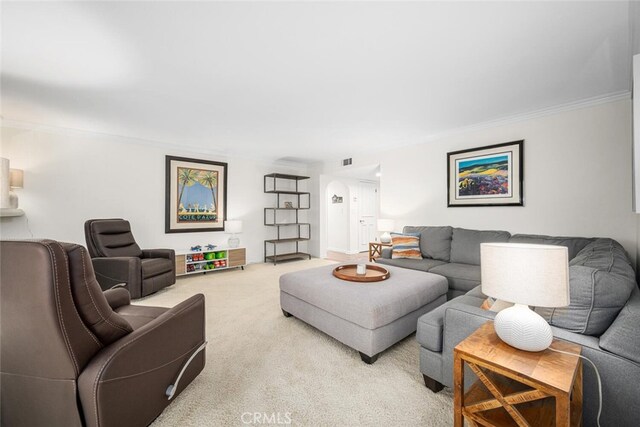 living room with visible vents, carpet, and crown molding