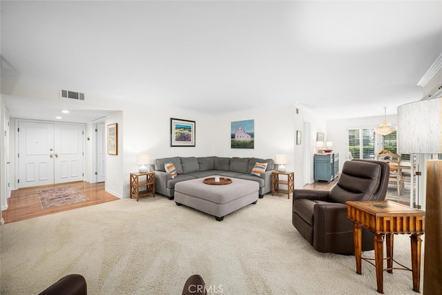 carpeted living room with baseboards and visible vents