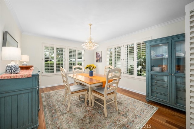 dining room featuring a wealth of natural light, ornamental molding, and a chandelier