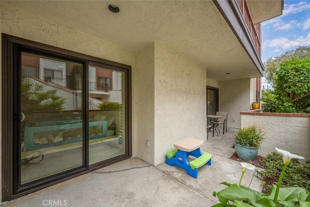 exterior space featuring a patio area and stucco siding