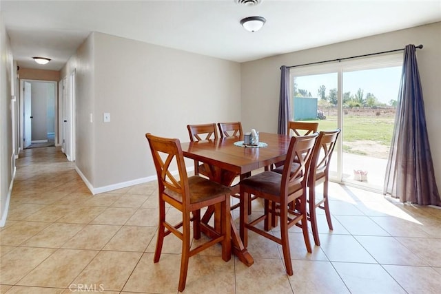 dining space with light tile patterned flooring, visible vents, and baseboards