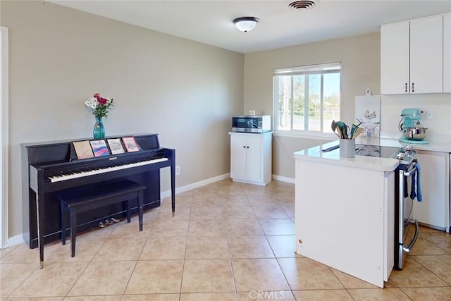 kitchen featuring stainless steel appliances, visible vents, white cabinetry, light countertops, and light tile patterned floors