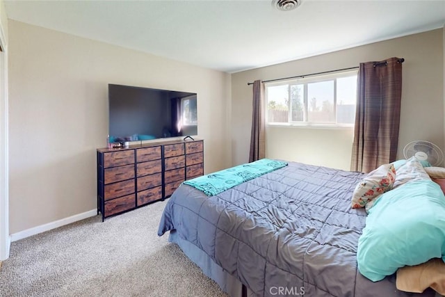 carpeted bedroom featuring visible vents and baseboards