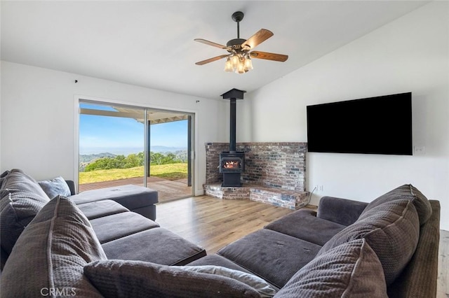 28383 Shady Oaks Rd, Clovis, CA 93619 - living room with vaulted ceiling, wood finished floors, a wood stove, and ceiling fan
