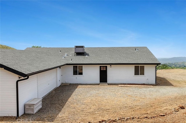 28383 Shady Oaks Rd, Clovis, CA 93619 - view of front of home featuring central AC unit, roof with shingles, a garage, and a mountain view
