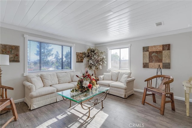 living area with wood finished floors, visible vents, baseboards, and wooden ceiling