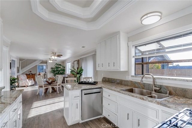 kitchen featuring dishwasher, a sink, white cabinetry, and a healthy amount of sunlight