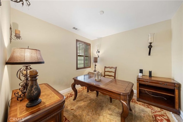 office space with baseboards and visible vents