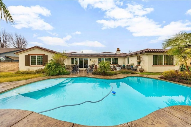 pool featuring fence and a patio area