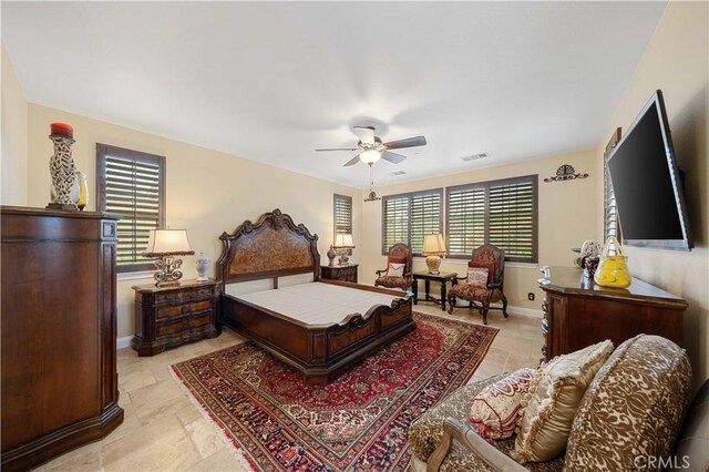 bedroom featuring baseboards and visible vents