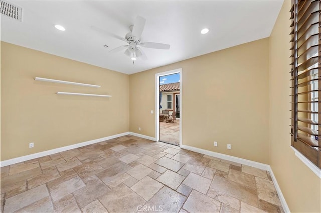 spare room featuring stone tile floors, baseboards, visible vents, recessed lighting, and ceiling fan