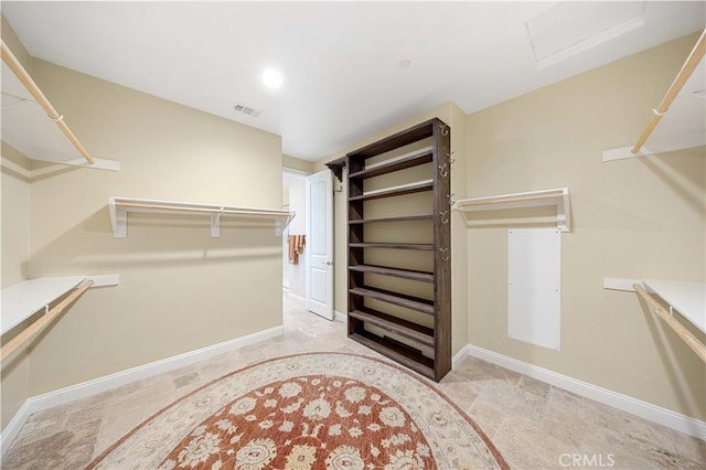 walk in closet featuring attic access and visible vents