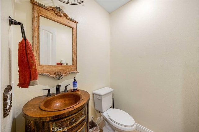 half bathroom featuring toilet and vanity