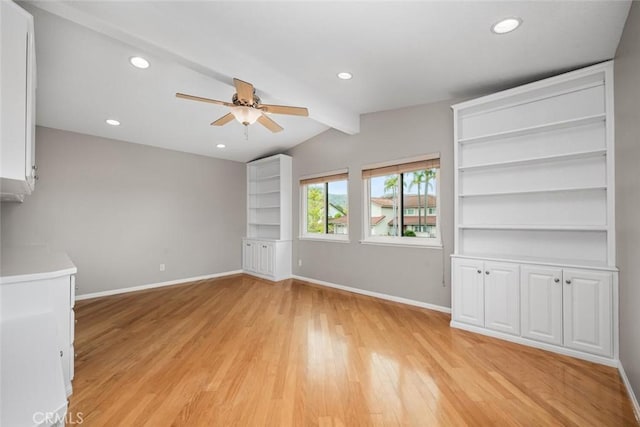 unfurnished living room with ceiling fan, baseboards, light wood-style floors, and vaulted ceiling with beams