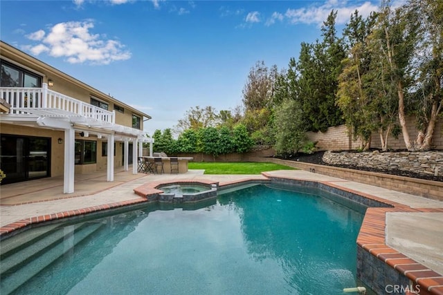 view of swimming pool featuring a fenced backyard, a patio, and a pool with connected hot tub