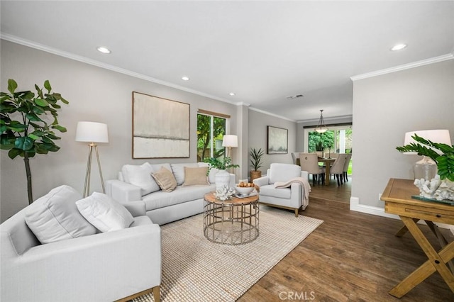 living room with dark wood-style floors, visible vents, baseboards, recessed lighting, and ornamental molding