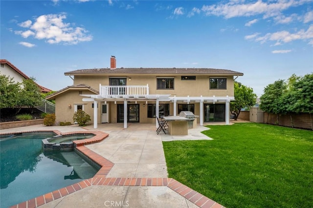 rear view of house featuring a pergola, outdoor dry bar, a lawn, a pool with connected hot tub, and stucco siding
