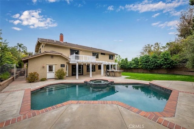 back of property with a patio area, a fenced backyard, a chimney, and stucco siding