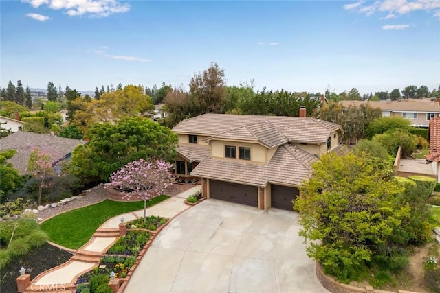 4805 Via Amante, Yorba Linda, CA 92886 - view of front of property featuring a tile roof, driveway, an attached garage, a chimney, and stucco siding
