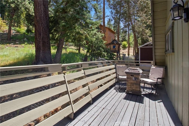 wooden deck featuring an outdoor fire pit