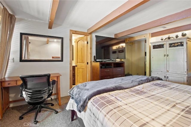 carpeted bedroom with beamed ceiling
