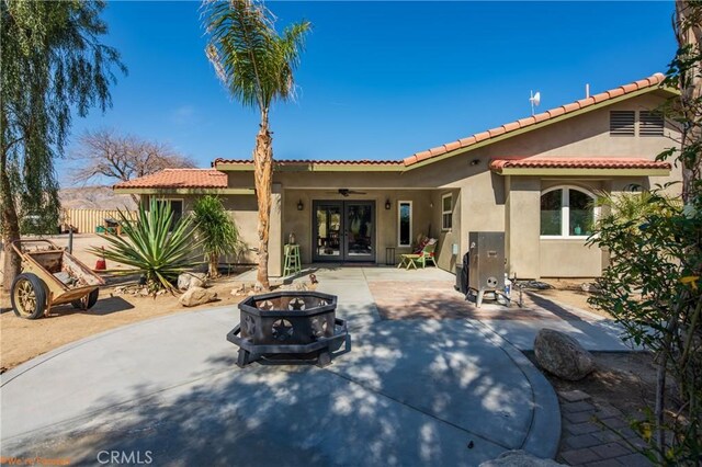 73950 22nd Ave, Desert Hot Springs, CA 92241 - back of property featuring a ceiling fan, french doors, a patio area, stucco siding, and a fire pit