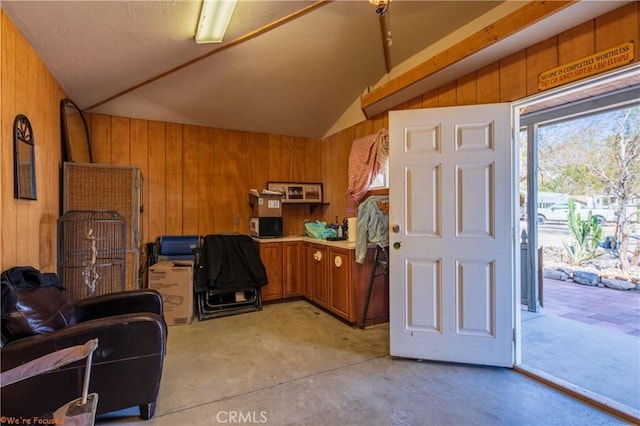 73950 22nd Ave, Desert Hot Springs, CA 92241 - foyer with vaulted ceiling, wood walls, and concrete flooring