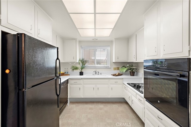 174 Avenida Majorca Unit A, Laguna Woods, CA 92637 - kitchen featuring a sink, white cabinetry, and black appliances