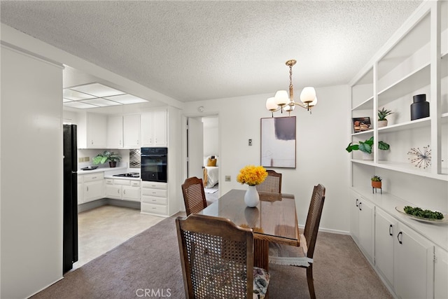 174 Avenida Majorca Unit A, Laguna Woods, CA 92637 - dining room featuring a textured ceiling, a notable chandelier, and light colored carpet