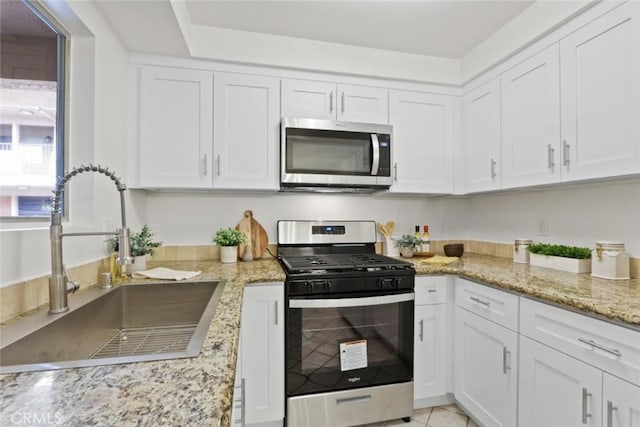 2501 W Redondo Beach Blvd Unit 238, Gardena, CA 90249 - kitchen featuring light stone countertops, white cabinetry, stainless steel appliances, and a sink