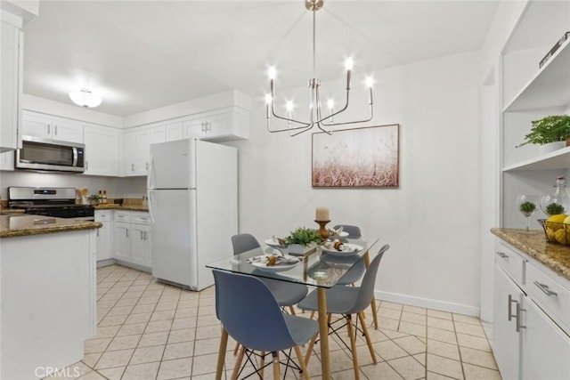 2501 W Redondo Beach Blvd Unit 238, Gardena, CA 90249 - kitchen with white cabinetry, light tile patterned floors, stainless steel appliances, and an inviting chandelier