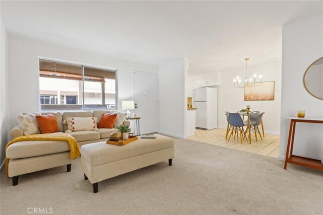 2501 W Redondo Beach Blvd Unit 238, Gardena, CA 90249 - living room featuring light carpet, baseboards, and an inviting chandelier