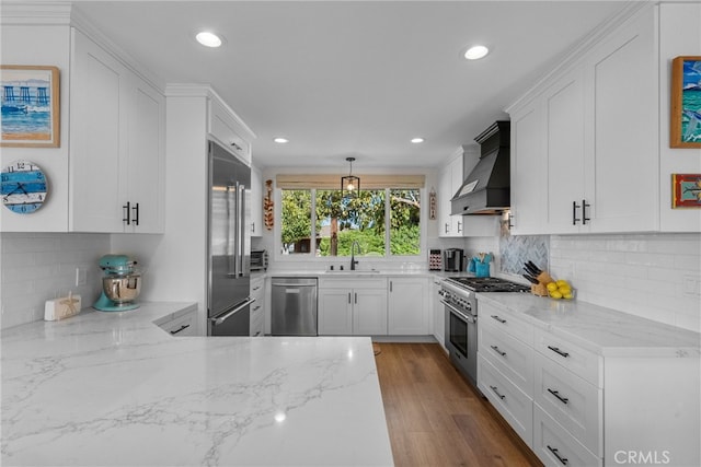 27361 Rainbow Ridge Rd, Palos Verdes Peninsula, CA 90274 - kitchen with high end appliances, custom range hood, a sink, white cabinets, and recessed lighting
