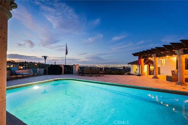 pool at dusk with a pergola, an outdoor pool, and a patio area