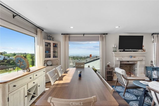 27361 Rainbow Ridge Rd, Palos Verdes Peninsula, CA 90274 - dining space featuring wood finished floors, recessed lighting, and a lit fireplace