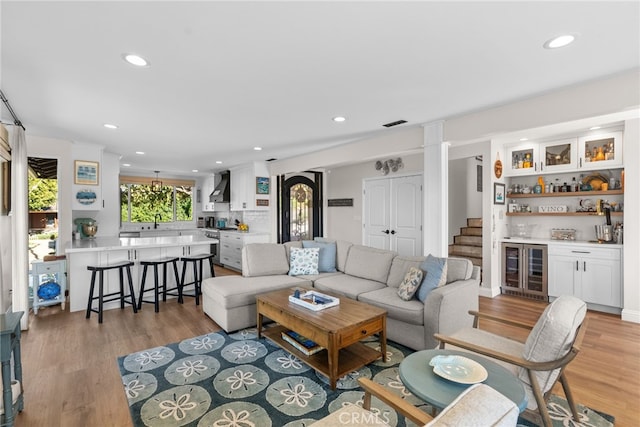 27361 Rainbow Ridge Rd, Palos Verdes Peninsula, CA 90274 - living room featuring bar area, wine cooler, recessed lighting, and light wood finished floors