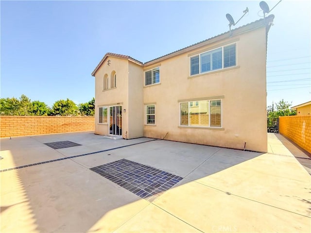 back of house with a patio, a fenced backyard, and stucco siding