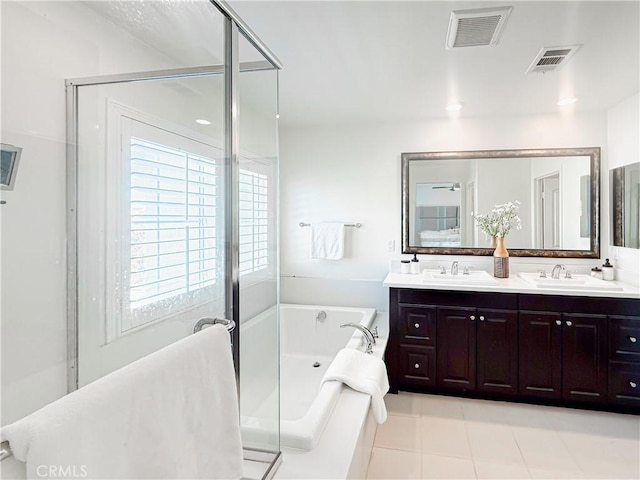 full bathroom with double vanity, visible vents, a bath, and a sink