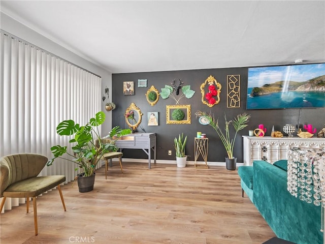 904 Pinon Dr, Barstow, CA 92311 - living area featuring wood finished floors, an accent wall, and baseboards