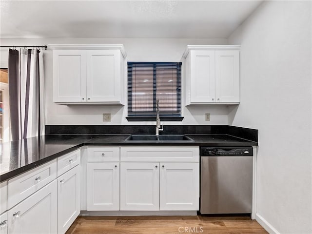 904 Pinon Dr, Barstow, CA 92311 - kitchen featuring stainless steel dishwasher, white cabinetry, a sink, light wood-type flooring, and dark stone counters