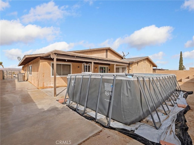 904 Pinon Dr, Barstow, CA 92311 - rear view of house featuring stucco siding and a patio