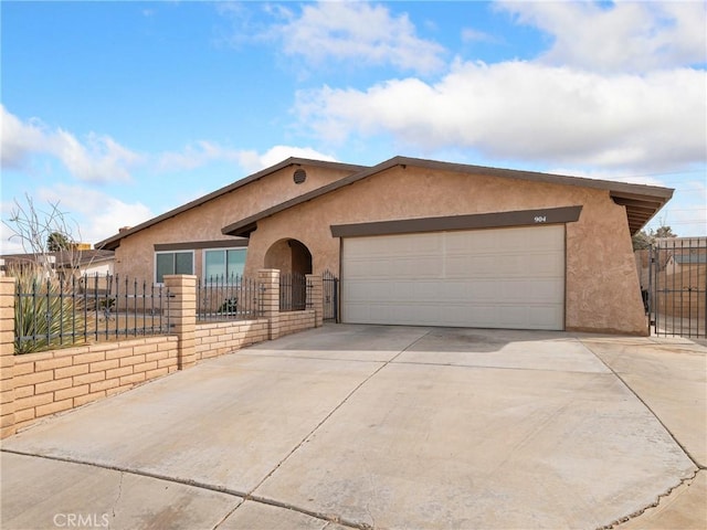 904 Pinon Dr, Barstow, CA 92311 - single story home featuring stucco siding, a garage, driveway, and a gate