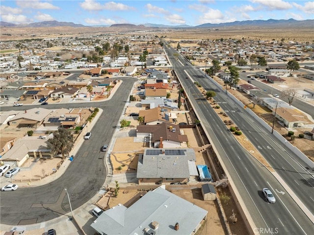 904 Pinon Dr, Barstow, CA 92311 - aerial overview of property's location featuring a mountain backdrop, nearby suburban area, and a highway