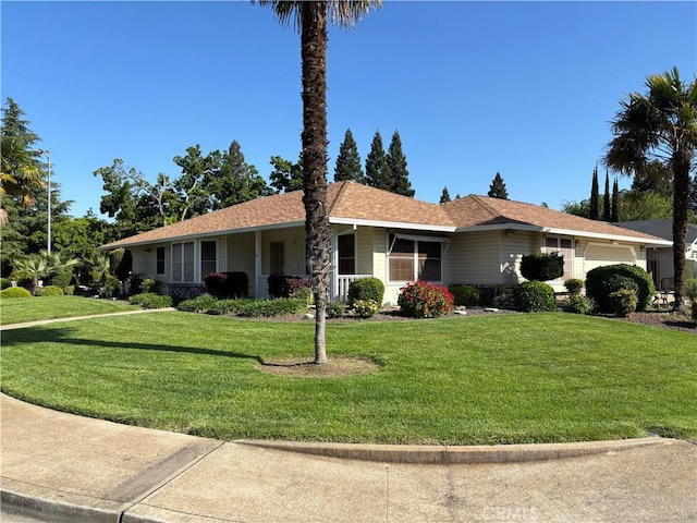 ranch-style home featuring an attached garage and a front yard