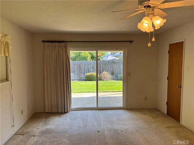 carpeted empty room featuring ceiling fan
