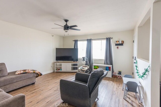 9213 Jacaranda Ave, California City, CA 93505 - living room featuring a ceiling fan and light wood-style flooring
