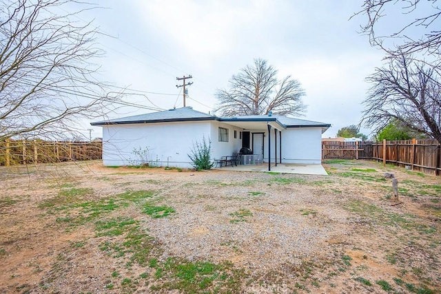 9213 Jacaranda Ave, California City, CA 93505 - rear view of property with a fenced backyard, a patio, and stucco siding