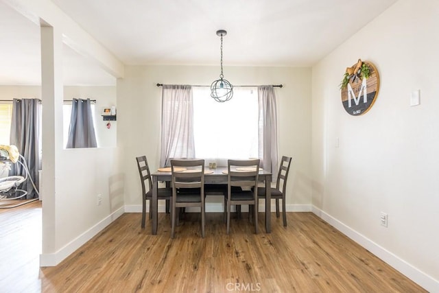 9213 Jacaranda Ave, California City, CA 93505 - dining room featuring healthy amount of natural light, wood finished floors, and a chandelier