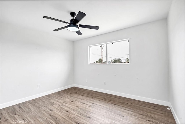 9213 Jacaranda Ave, California City, CA 93505 - empty room featuring wood finished floors and ceiling fan