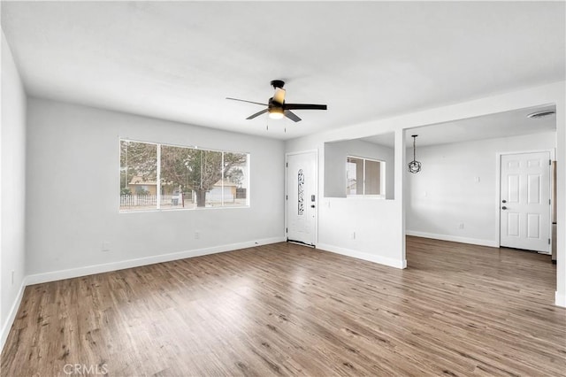 9213 Jacaranda Ave, California City, CA 93505 - unfurnished living room with ceiling fan and wood finished floors